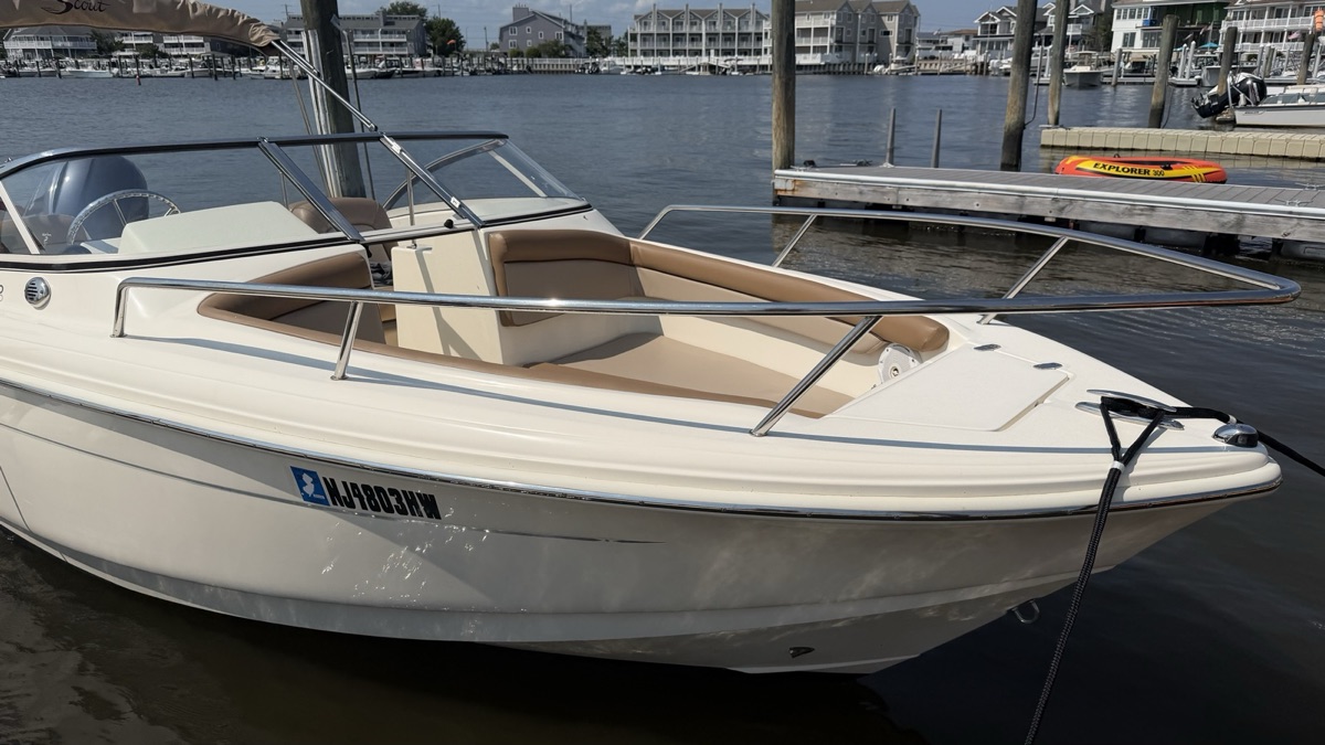 A Scout dual console tied up at its slip, hull and stainless rails cleaned.