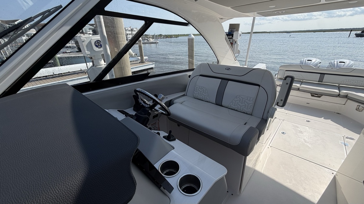 The helm seat and windshield, glass cleared of salt.